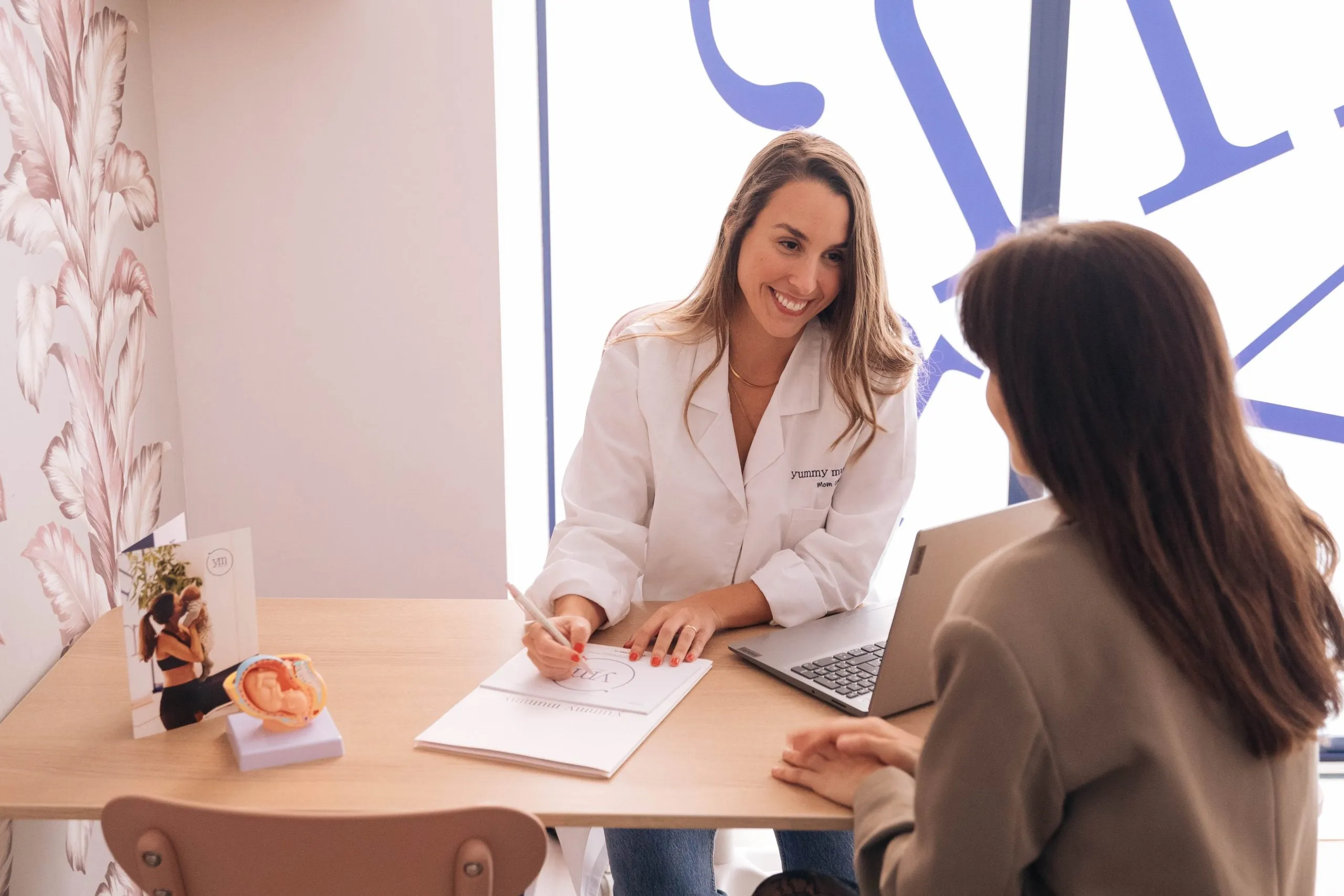 Doctora conversando con una paciente en su consulta